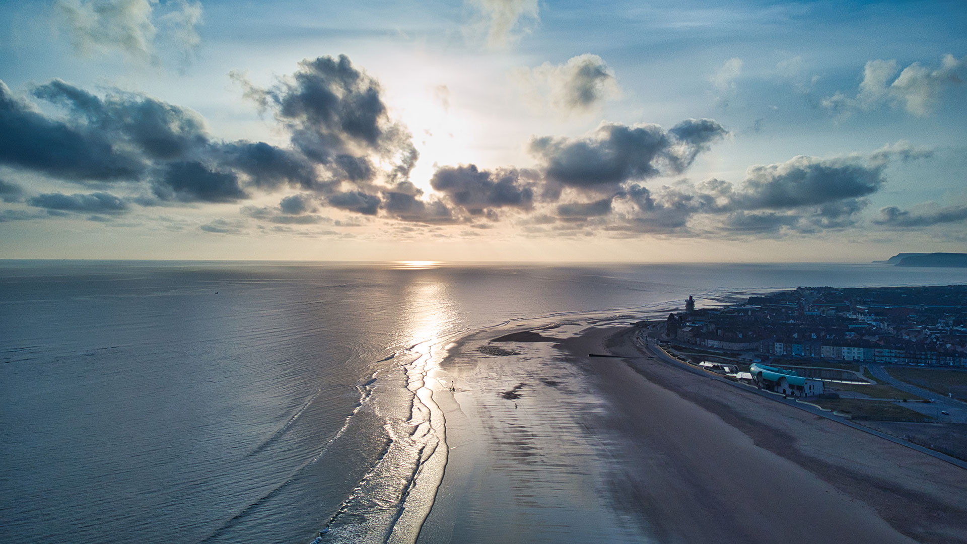 Aerial view of the rising sun reflected on a beach in North Sea, Coatham.